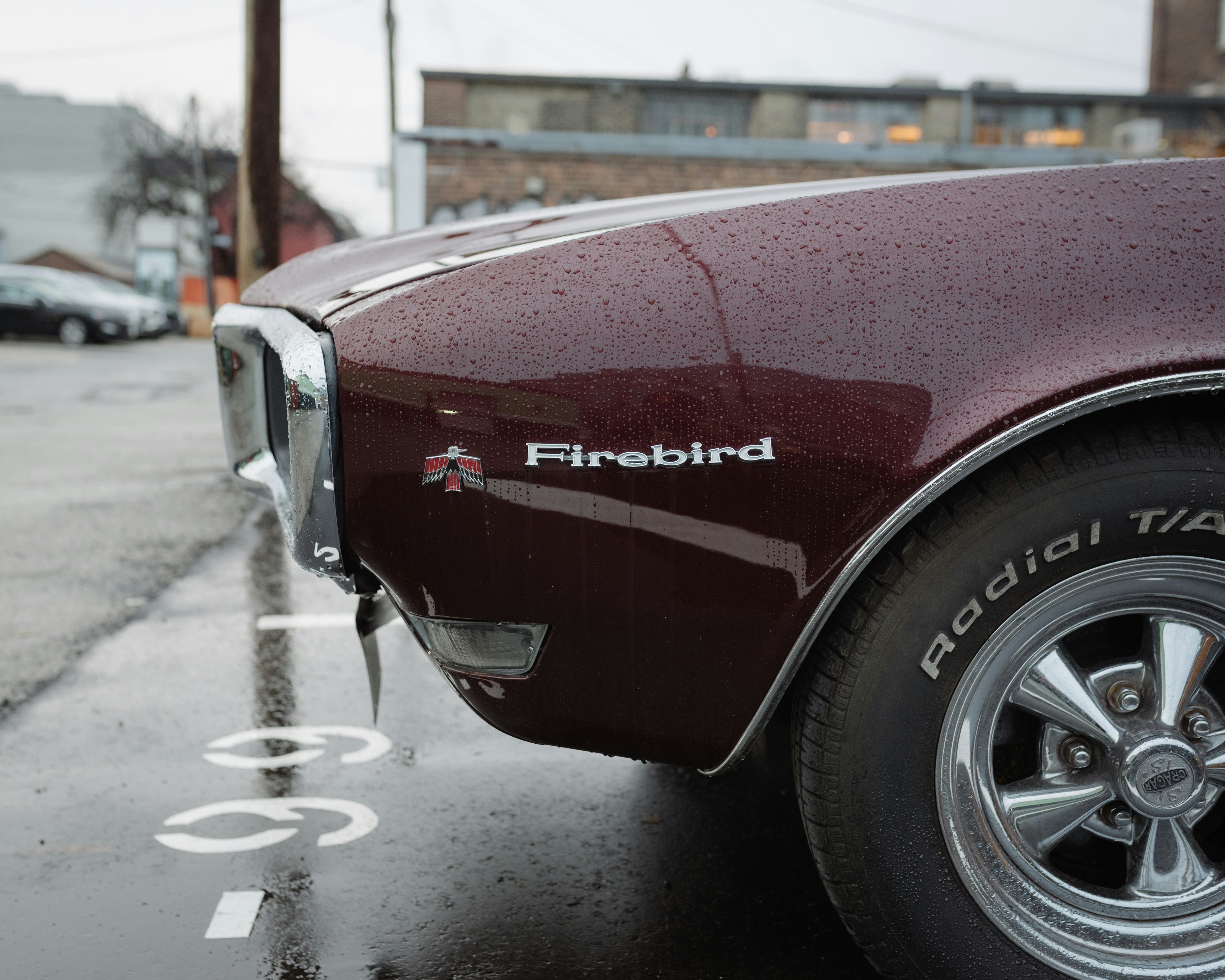 red car on gray asphalt road during daytime